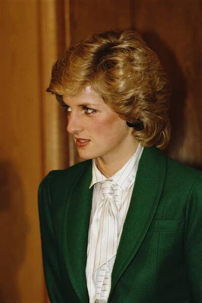 Princess Diana wearing a white tie and green jacket