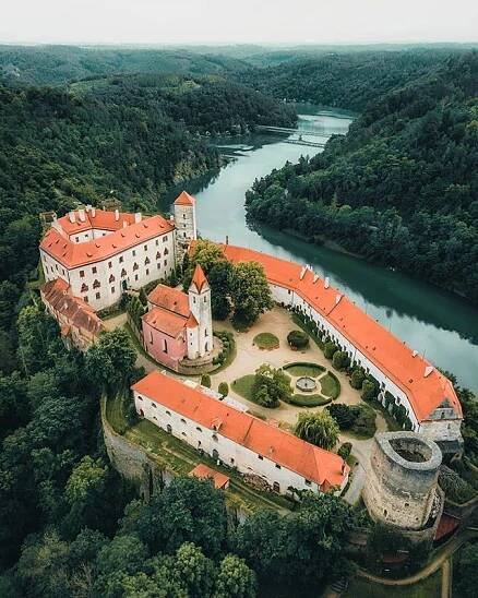 an aerial view of a castle surrounded by trees