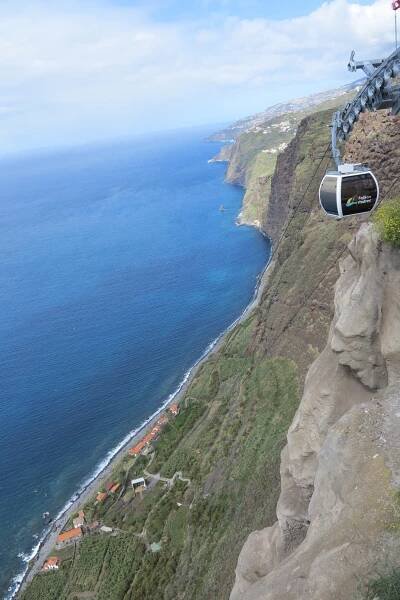 Breathtaking Cliffside View of the Coastline – A stunning aerial view of a long, dramatic coastline with high cliffs.