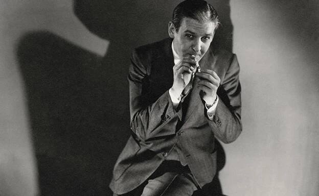 Vanity Fair studio portrait of American newspaper and radio commentator Walter Winchell half-sitting on a stool and lighting a cigarette. 1930 (Photo by Edward Steichen/Condé Nast via Getty Images)