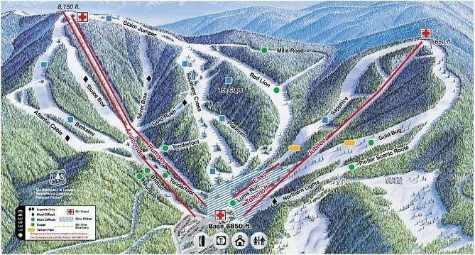 Illustrated ski trail map of Discovery Ski Area depicting a snowy mountain with various labeled trails, lodges, and checkpoints. Includes colorful lines marking different difficulty levels. Icons indicate amenities like restrooms and first aid stations. Elevations are noted.