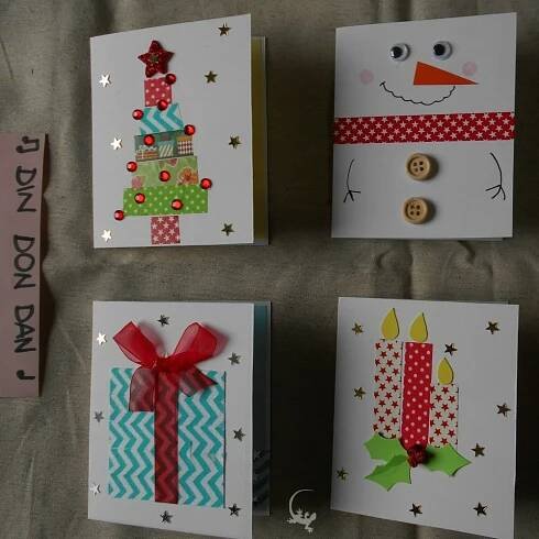 four christmas cards with different designs on them and buttons attached to the front of each card