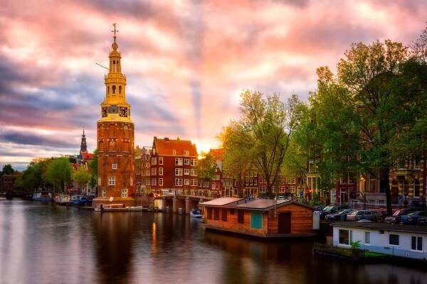 Amsterdam, Montelbaanstoren at sunset – canal view, the Netherlands.