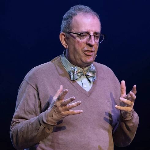 Richard talking on stage. Wearing a bow tie