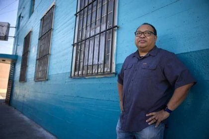 Dillon Delvo, executive director of Little Manila Rising, stands in front of a building that was originally the Filipino Recreation Hall, but is now boarded up and unoccupied, in the Little Manila neighborhood of Stockton on Oct. 13, 2021. Photo by Fred Greaves for CalMatters