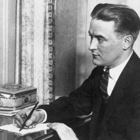 F. Scott Fitzgerald writing at a desk. A new cocktail named after the author is gaining popularity at bars across the globe.
