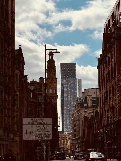 A city street filled with lots of tall buildings