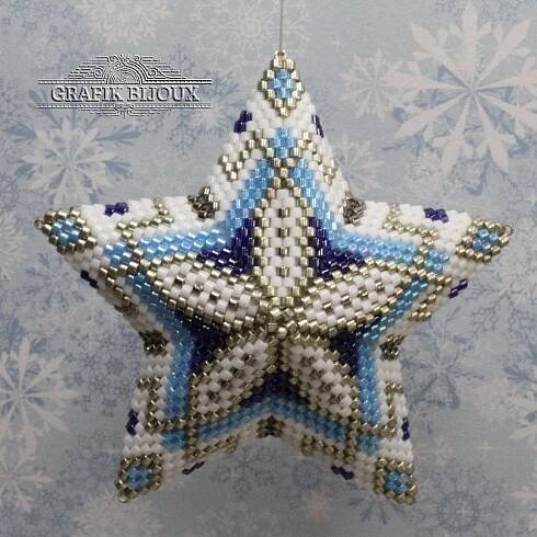 a blue and white beaded star ornament hanging from a hook on a wall