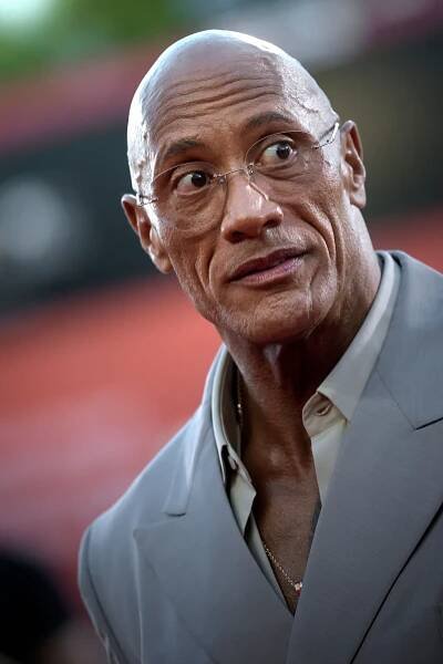 Dwayne Johnson in a gray suit.
