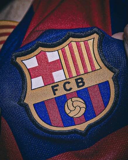 closeup of the emblem on a soccer jersey that is red, yellow and blue