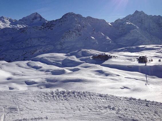 the sun shines brightly on snow covered mountains