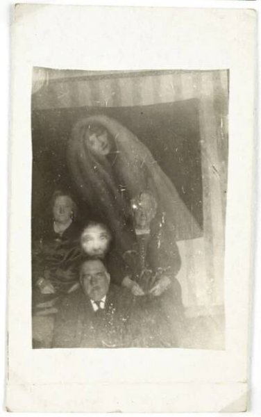 Three people with two spirits (photograph)