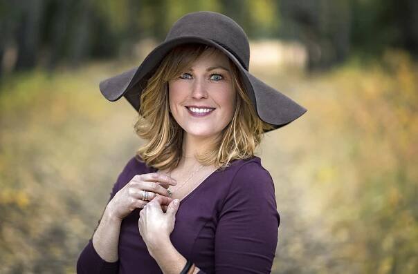 A young woman with blue eyes poses for a portrait on a beautiful fall day near Kamloops, British Columbia, Canada, Thompson Okanagan region