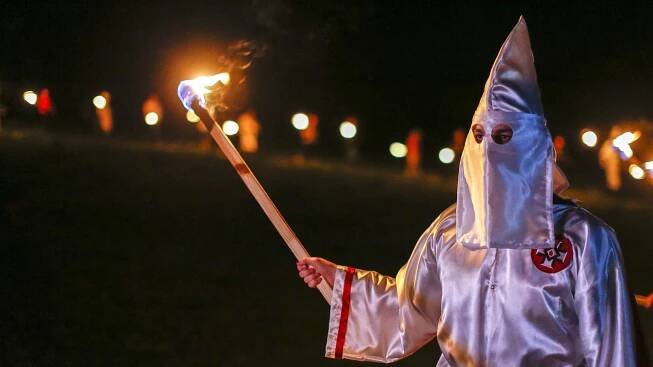 Mitglied des Ku Klux Klan mit brennender Fackel