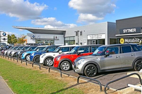 Row of used Mini Coopers at a car dealership.
