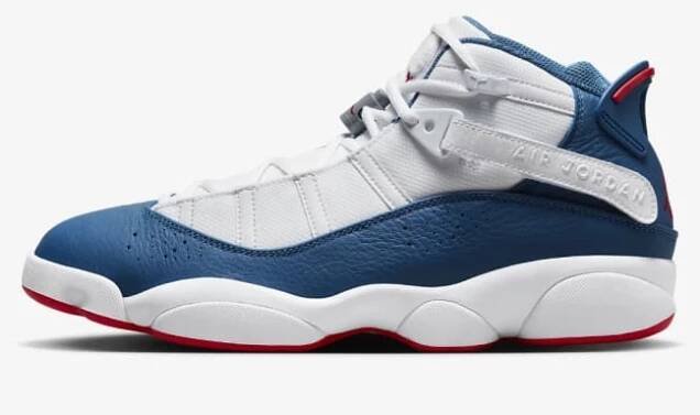 White, blue, and red Nike Jordan 6 Rings basketball shoe on a grey background.