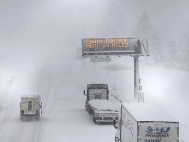 Powerful winter storm in California shuts interstate and dumps 10ft of snow on mountains
