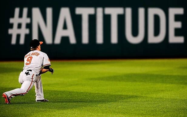 Nate Mclouth, Baltimore Orioles left fielder warms up during game against the Washington Nationals at National Park on June 29, 2013 in Washington, D.C.   