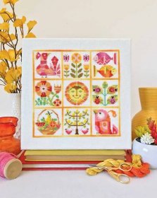 Photo of a seasonal Summer cross stitched sampler in shades of yellow and pink.