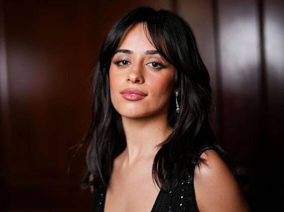 Camila Cabello poses in semi-sheer blouse and micro shorts at the French Riviera