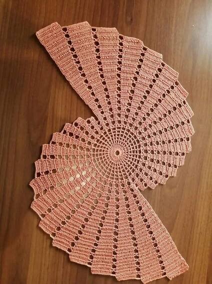 two crocheted doily on a wooden surface