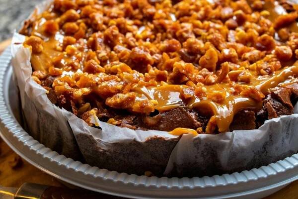 Free Mouth-watering caramel nut cake with a rich, delicious topping, perfect for dessert lovers. Stock Photo