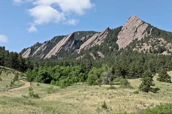 The Flatirons overlooking Boulder, Colorado are comprised of once flat-lying Permian Fountain Formation sedimentary rock that were tilted to 50 degrees by the orogenic uplift of the Rocky Mountains. Photo credit: Vince Matthews for the CGS.