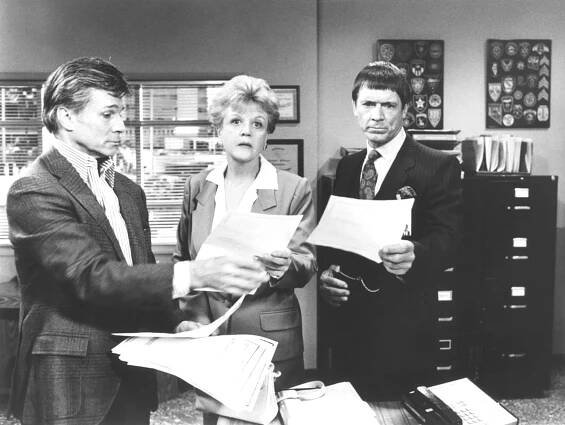 Black and white photo of Angela Lansbury, Chad Everett, and George Maharis in a scene from *Murder, She Wrote*.