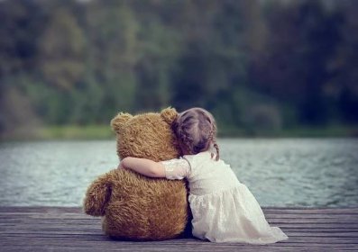 Child Hugging A Teddy Bear Wallpaper