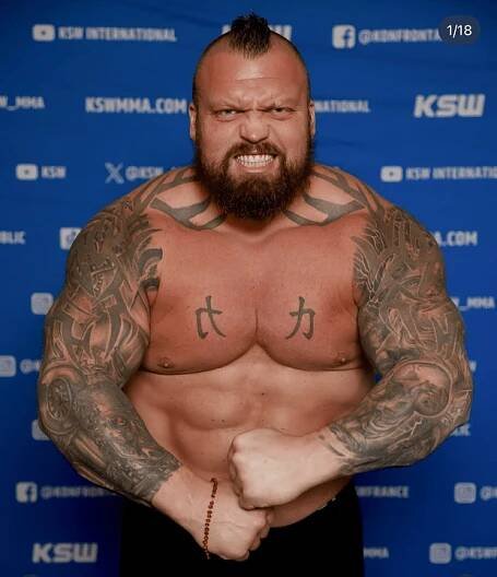 Hafþór Júlíus Björnsson, shirtless, flexing his biceps.