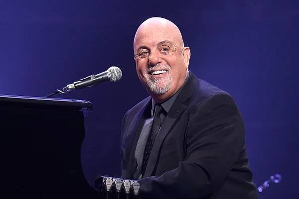 Billy Joel plays the piano