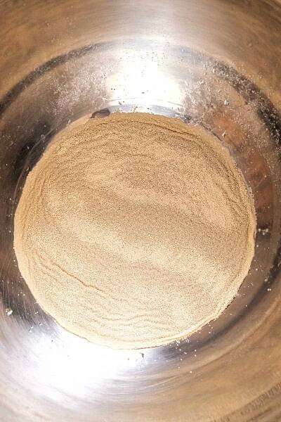 A close up of a metal bowl with yeast in it.