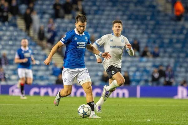 Rangers FC player controlling the ball during a match.