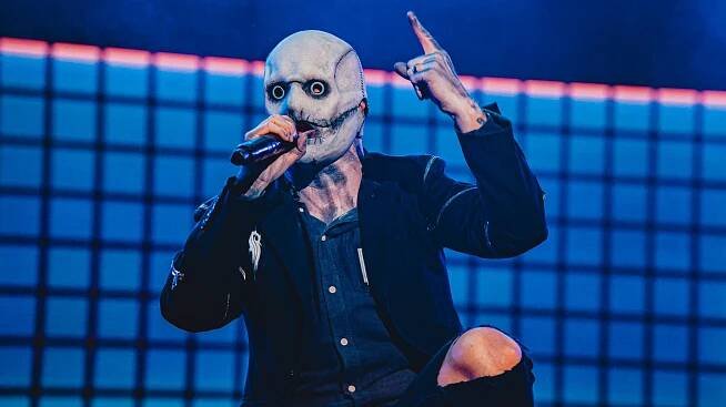 Slipknot's Corey Taylor holding his finger up in the air during a concert