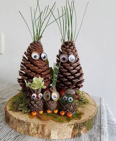 three pine cones with googly eyes on them
