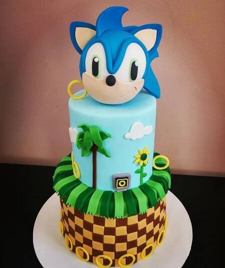 a sonic the hedgehog cake with palm trees and checkerboard design on top