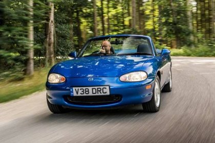 Mazda MX-5 1998 front driving through forest