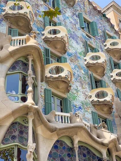 angled image of Casa Batllo in Barcelona with the windows and colorful walls as a close up.