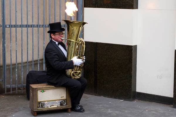 A man busking with a tuba that shoots fire in London, UK. Photo: Ed Brown / Al