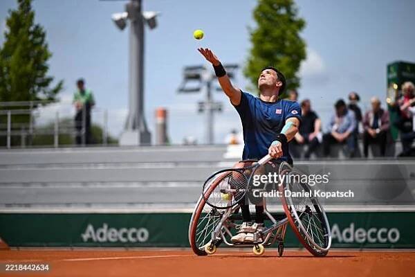 Gordon Reid of Great Britain in action against Nicolas Charrier of France during the Men's Wheelchair Singles First Round match on Day Ten of the...