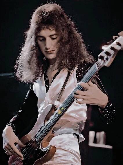 a man with long hair playing an electric guitar