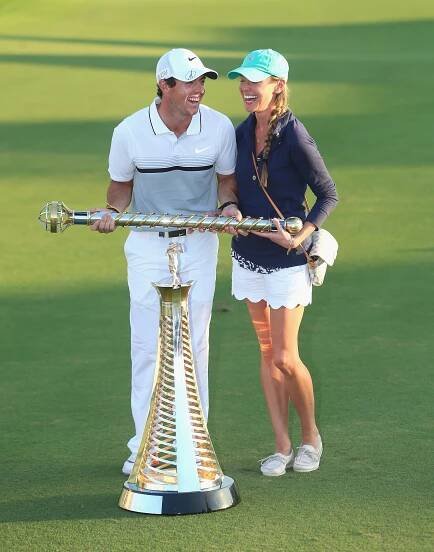 Rory McIlroy of Northern Ireland and his then-girlfriend Erica Stoll pose with the Race To Dubai and DP World Tour Championship trophies following the final round of the DP World Tour Championship on the Earth Course at Jumeirah Golf Estates on November 22, 2015 in Dubai, United Arab Emirates.  