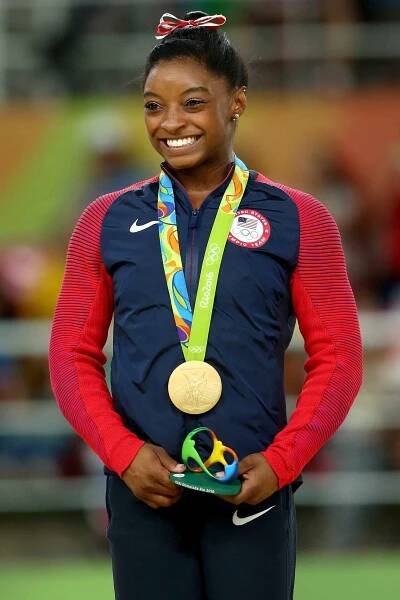 Gold medalist Simone Biles of the United States celebrates on the podium at the medal ceremony for Women's Vault on Day 9 of the Rio 2016 Olympic Games at the Rio Olympic Arena on August 14, 2016 in Rio de Janeiro, Brazil. (