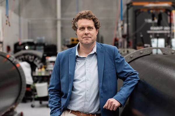 Peter Beck standing in a factory.