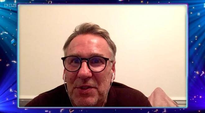a man wearing glasses and ear buds is on a video call