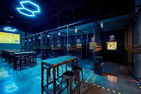 Image shows a gallery of axe-throwing booths at iCompete entertainment venue in Dallas.