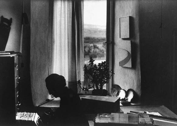 Georgia O'Keeffe rummaged through piles of photographs.