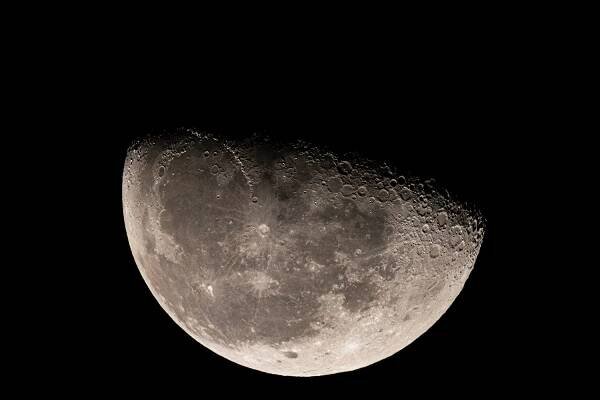 Big Moon in waning gibbous phase, in black background.