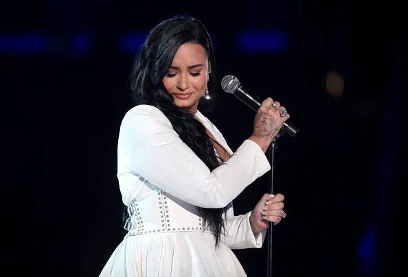 FILE - Demi Lovato performs Anyone at the 62nd annual Grammy Awards on Jan. 26, 2020, in Los Angeles. Lovato revealed on Wednesday, May 19, 2021, they identify as nonbinary and are changing their pronouns, telling fans the decision came after self-reflective work. Lovato said they picked gender-neutral pronouns them and they as this best represents the fluidity I feel in my gender expression. (Photo by Matt Sayles/Invision/AP, File)