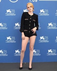 Kristen Stewart offers an eyeful of her toned legs in a black tweed Chanel romper